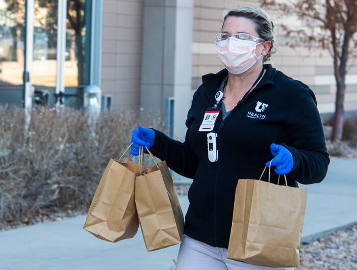 (Rick Egan | The Salt Lake Tribune)  Sharlene Heward delivers grilled cheese sandwiches for 600 health care workers as part of the the Curds + Kindness program, which supports local dairy farmers, at the South Jordan Health Center in Daybreak on Tuesday, Dec. 1, 2020.