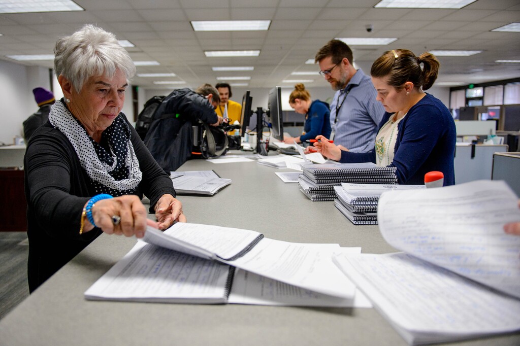 (Trent Nelson  |  The Salt Lake Tribune) Judy Weeks Rohner, left, turns in signed tax referendum petitions to staffers at the Salt Lake County Clerk's Office in Salt Lake City on Tuesday, Jan. 21, 2020. At right are Bret Chappell and Olivia Spencer.