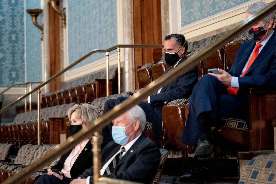 (Erin Schaff | The New York Times) Sen. Mitt Romney, R-Utah, and others watch as a joint session of the House and Senate convenes to confirm the Electoral College votes cast in November's election, at the Capitol in Washington, Wednesday, Jan. 6, 2021.