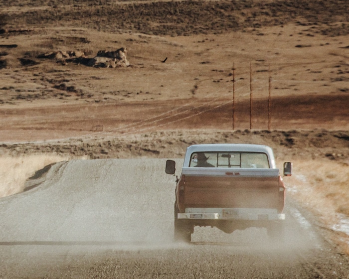 (Elliot Ross | The New York Times) A truck kicks up dust along Road 3Cq near Cody, Wyo., Jan. 28, 2020. Last September, The Cody Enterprise reported that Kanye West bought a property called Monster Lake Ranch, about eight miles outside Cody.