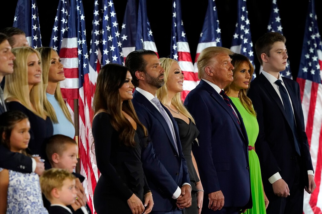 (Alex Brandon | AP file photo)  From left, Jared Kushner and his wife Ivanka Trump, Eric and Lara Trump, Kimberly Guilfoyle and Donald Trump Jr., Tiffany Trump, President Donald Trump and first lady Melania Trump and Barron Trump stand on stage on the South Lawn of the White House on the fourth day of the Republican National Convention, Thursday, Aug. 27, 2020, in Washington.