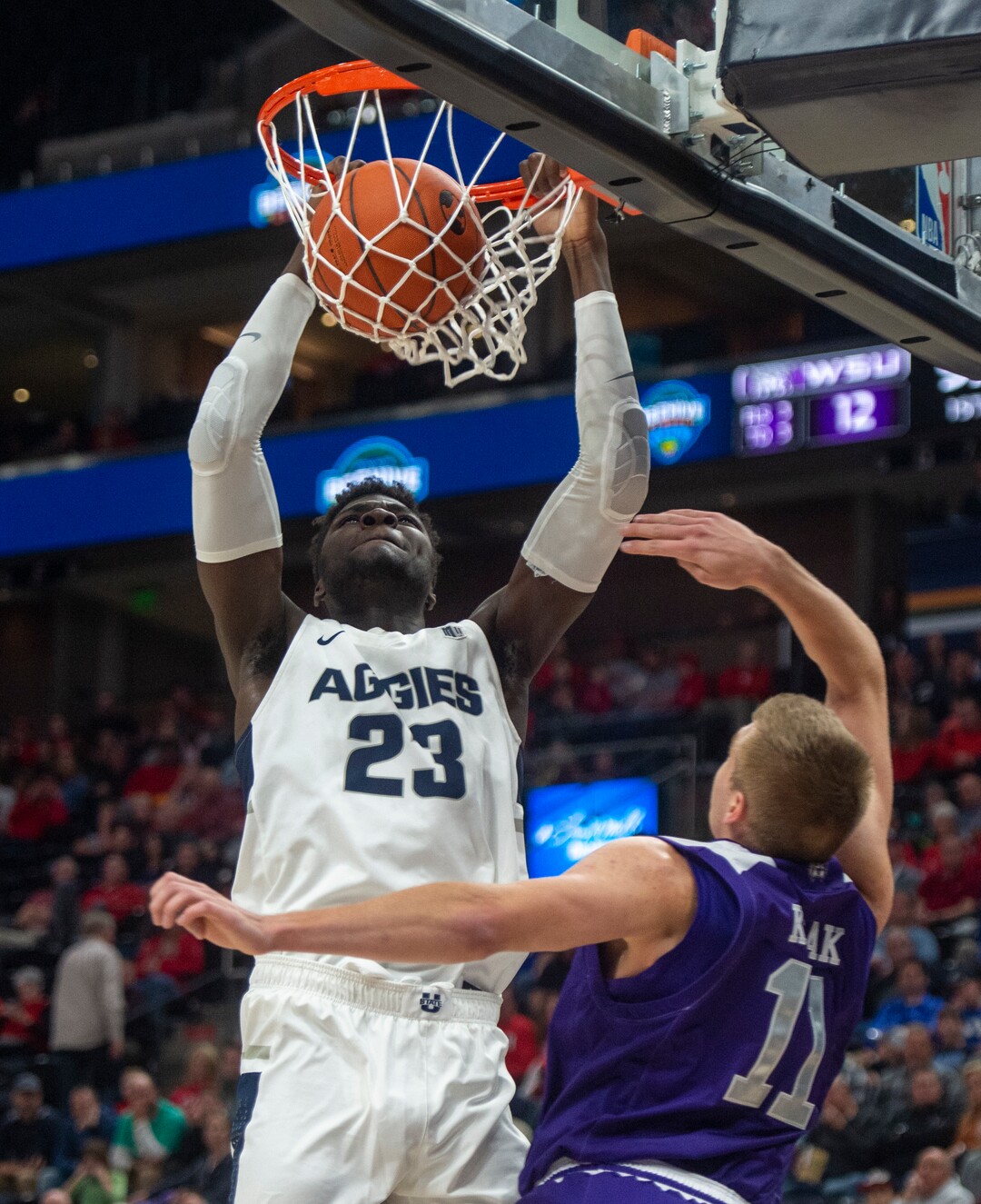 (Rick Egan  |  The Salt Lake Tribune)   Utah State Aggies center Neemias Queta (23) dunks the ball, as Weber State Wildcats forward Michal Kozak (11) defends, in basketball action in the Beehive Classic, between against the Utah State Aggies and Weber State Wildcats, a the Vivint Smart Home Arena, Saturday December 8, 2018. 
