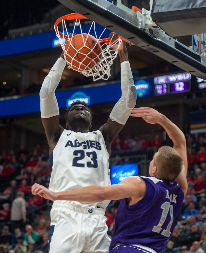 (Rick Egan  |  The Salt Lake Tribune)   Utah State Aggies center Neemias Queta (23) dunks the ball, as Weber State Wildcats forward Michal Kozak (11) defends, in basketball action in the Beehive Classic, between against the Utah State Aggies and Weber State Wildcats, a the Vivint Smart Home Arena, Saturday December 8, 2018.

 