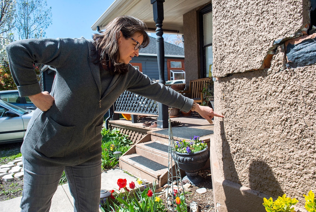 (Rick Egan  |  The Salt Lake Tribune)   Gloria Munns checks out the cracks in her Salt Lake City home, caused by the earthquake, Monday April 13, 2020