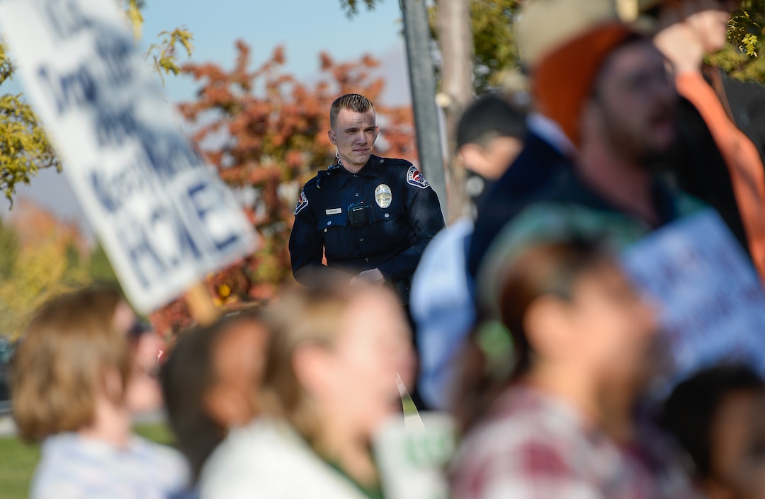 (Francisco Kjolseth  |  The Salt Lake Tribune)  Police keep a watchful eye as community members rally in front of the Immigration and Customs Enforcement offices in West Valley City on Monday, Oct. 16, 2017, to support Maria Santiago Garcia, a single Utah mother of four U.S. born children who faces an impending deportation order.