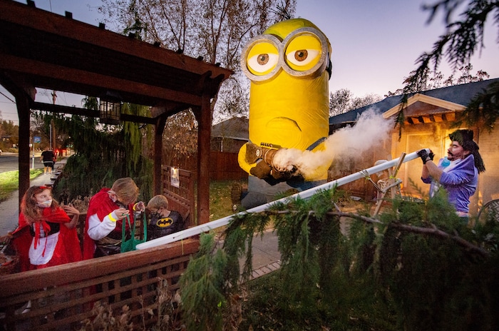 (Francisco Kjolseth  |  The Salt Lake Tribune) Ammon Smith dressed as the villain Balthazar Bratt from the movie Despicable Me goes big with his creation of a 25-foot Kevin, complete with fart gun in Sugar House on Saturday, Oct. 31, 2020, where he used a long tube to deliver candy for kids in an effort to stay safe during COVID-19 for this Halloween.