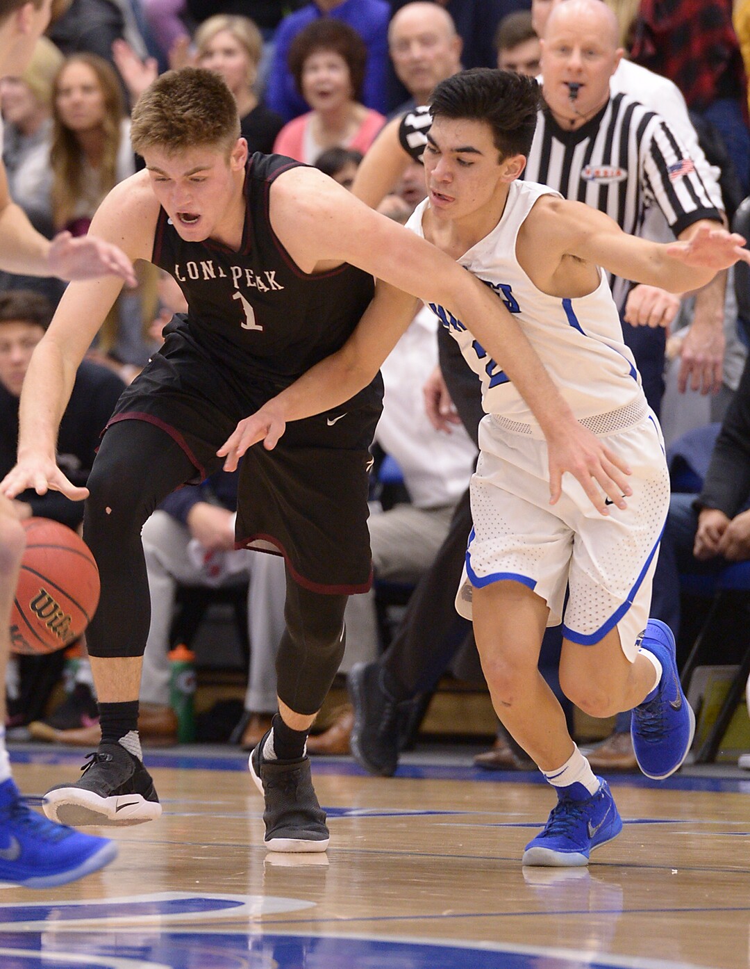 (Leah Hogsten  |  The Salt Lake Tribune) Pleasant Grove's Kawika Akina fights for possession with Lone Peak's Max Brenchley.  Pleasant Grove High School boys' basketball team leads Lone Peak High School 26-20 during their game Friday, January 26, 2018 in Pleasant Grove. 