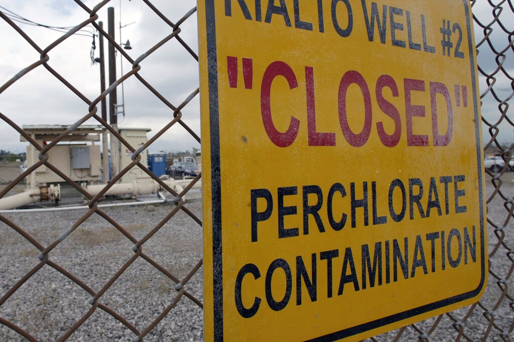 (Ric Francis | AP file photo)  In this March 28, 2005, photo a sign posted outside a water well indicates perchlorate contamination at the site in Rialto, Calif.