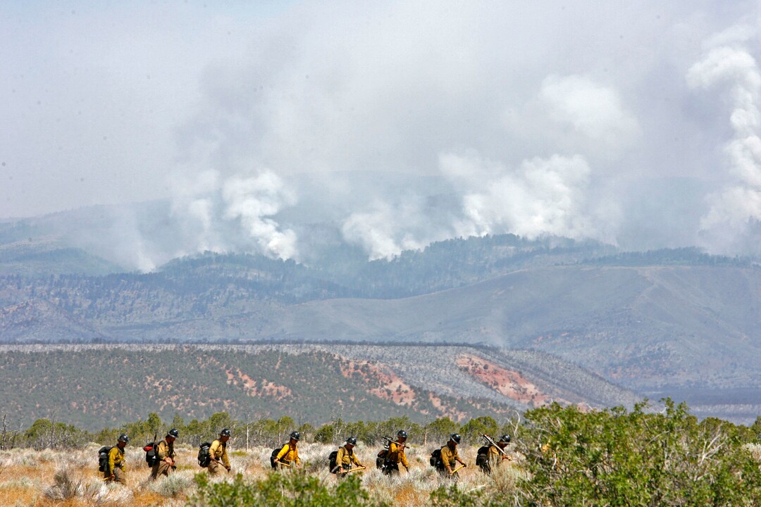 (Danny Chan La  |  Tribune file photo)  In this 2007 file photo, fire suppression crews, "hotshots,"  hike out on the Neola Fire. The blaze killed three people and burned 43,806 acres.