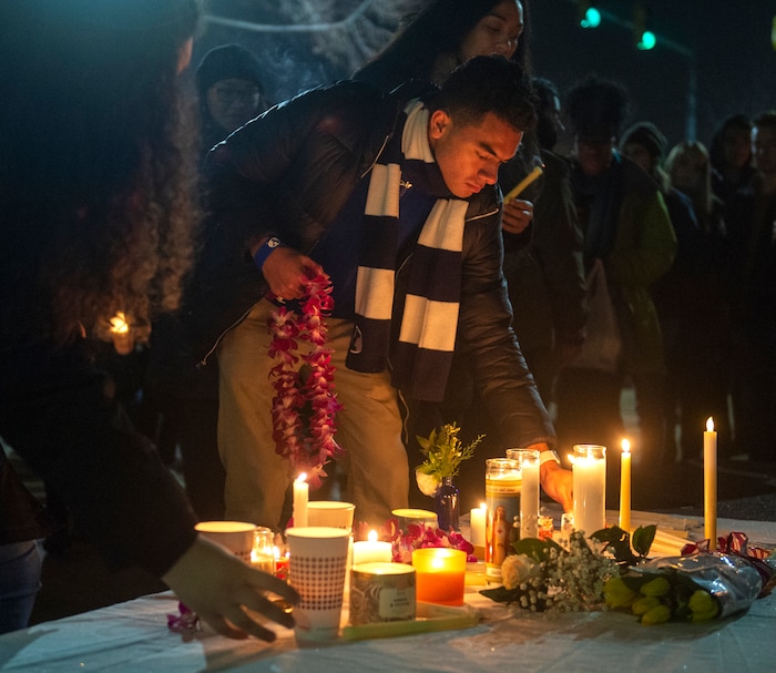 (Rick Egan  |  The Salt Lake Tribune)      BYU students gather for a candlelight vigil on BYU campus, for the student who died by suicide this week, at the Tanner Building, Friday, Dec. 7, 2018.
  
