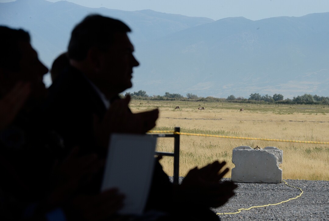 (Scott Sommerdorf   |  The Salt Lake Tribune)   As attendees applaud the speakers, pronghorn antelope graze in the fields beyond the tent hosting the groundbreaking ceremony for the new prison, Wednesday, August 16, 2017. 