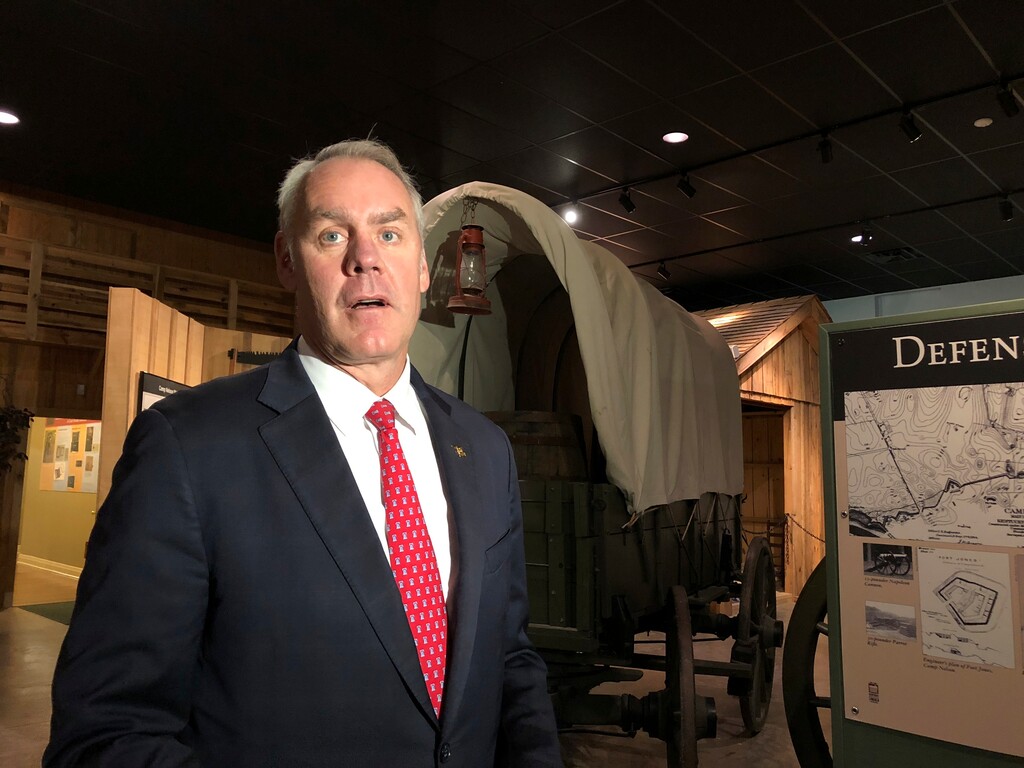 (AP Photo/Adam Beam) U.S. Interior Secretary Ryan Zinke speaks with reporters at the Camp Nelson National Monument on Saturday, Oct. 27, 2018, in Nicholasville, Kentucky. Camp Nelson was a Union Army depot during the U.S. Civil War and was a recruiting center for black soldiers. Zinke announced Saturday Camp Nelson has been officially designated as a national monument.