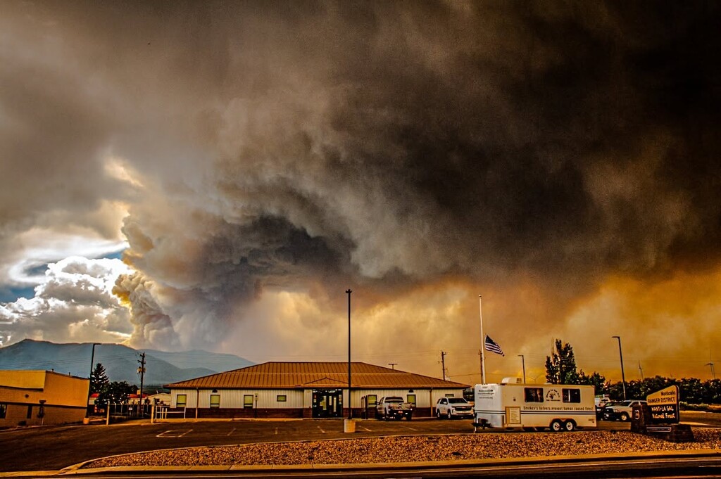 (U.S. Forest Service) Smoke from the Babylon Fire rises behind the U.S. Forest Service office in Monticello on July 6. The wildfire has burned more than 101,000 acres and reached 11% containment Wednesday.