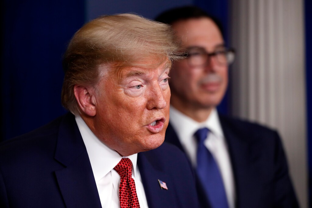 President Donald Trump speaks about the coronavirus in the James Brady Briefing Room, Wednesday, March 25, 2020, in Washington, as Treasury Secretary Steven Mnuchin listens. (AP Photo/Alex Brandon)