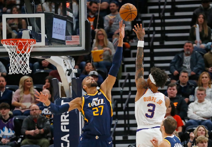 Utah Jazz center Rudy Gobert (27) defends against Phoenix Suns forward Kelly Oubre Jr. (3) in the first half during an NBA basketball game Monday, Feb. 24, 2020, in Salt Lake City. (AP Photo/Rick Bowmer)