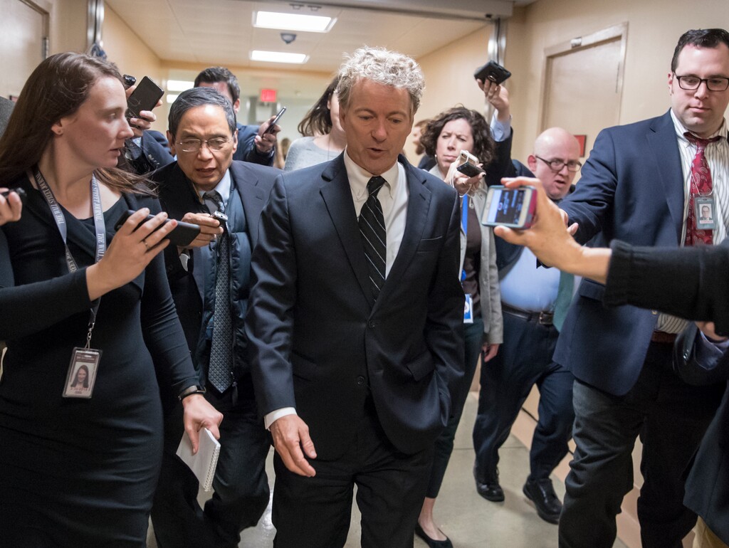 In this March 21, 2018, photo, Sen. Rand Paul, R-Ky., walks to the Senate floor for a vote with accompanying reporters, on Capitol Hill in Washington. As the Senate gets closer to another government funding deadline, Paul is protesting the pending $1.3 trillion spending bill, which he has called "budget-busting." (AP Photo/J. Scott Applewhite)