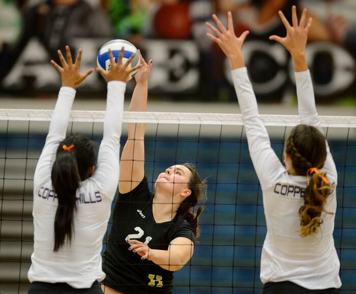 (Steve Griffin | The Salt Lake Tribune) Herriman's Gracie Malovich tries to hit the ball through the Copper Hills defense during volleyball match at Copper Hills High School in West Jordan Tuesday September 26, 2017.