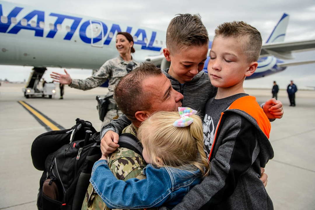 (Trent Nelson  |  The Salt Lake Tribune)  Sergeant First Class Thomas Crocker is welcomed home by his children Anabelle, Kaidin, and Bryson as almost 100 Soldiers from Utah Army National Guard’s Echo Battery, 1st Battalion, 145th Field Artillery, “Big Red” return after a 10-month Middle East deployment, on Tuesday April 9, 2019 at Wright Air Base in Salt Lake City.