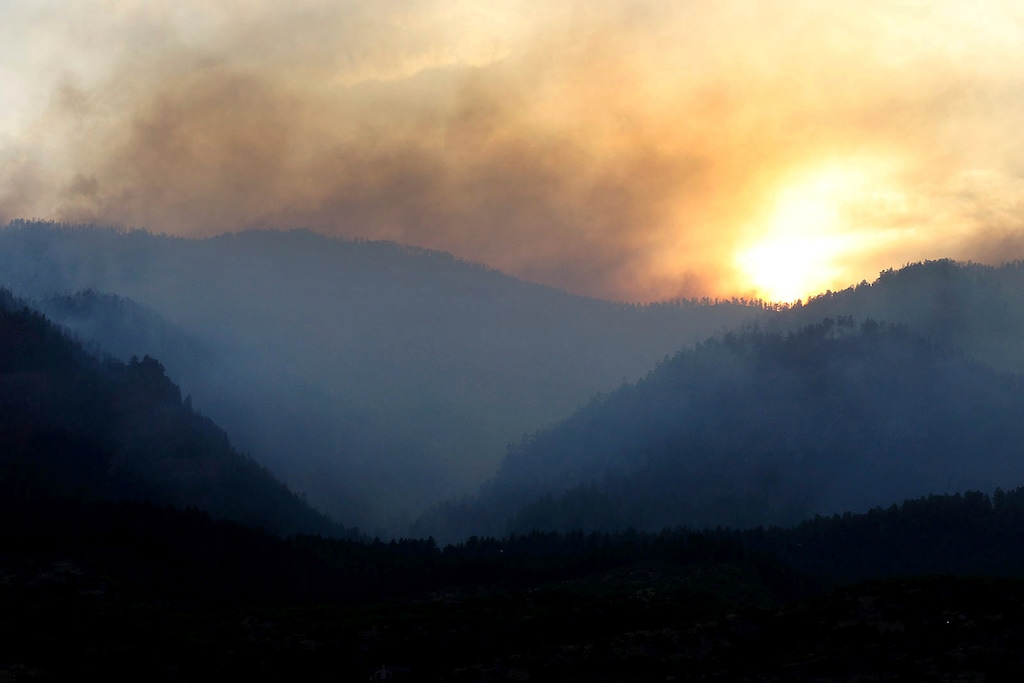(Jerry McBride/The Durango Herald via AP file) Smoke rises from the 416 Fire near Durango, Colo., as the sun sets on June 13, 2018. The U.S. Attorney’s Office filed a lawsuit on Tuesday, July 2, 2019, alleging that the fire was sparked by the Durango & Silverton Narrow Gauge Railroad. The fire burned about 85 square miles making it the sixth largest in state history.