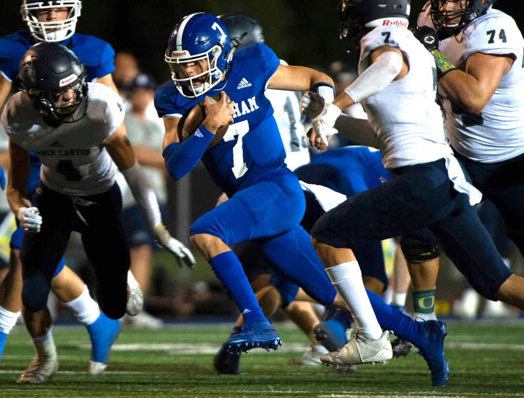 (Rick Egan  |  The Salt Lake Tribune)     Bingham quarterback Troy Mehn runs for a first down, in prep action between the Bingham Miners and the Corner Canyon Chargers, at Bingham High onFriday, Aug. 28, 2020.