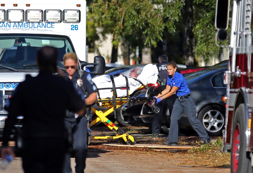 FILE- This Sept. 13, 2017, file photo, a patient is transported from The Rehabilitation Center at Hollywood Hills after a loss of air conditioning due to Hurricane Irma in Hollywood, Fla. Nine elderly patients died after being kept inside a nursing home that turned into a sweatbox when Hurricane Irma knocked out its air conditioning for three days, even though just across the street was a fully functioning and cooled hospital. Still, even with those facts, it's far from clear whether the deaths will result in a criminal prosecution. (Amy Beth Bennett/South Florida Sun-Sentinel via AP, File)
