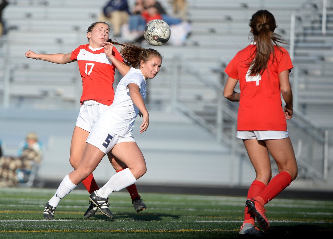 (Scott Sommerdorf   |  The Salt Lake Tribune)   East defender Kate Christensen and Corner Canyon's Karrera Passey battle for control of a header during second half play. East beat Corner Canyon 4-1 in a Class 5A girls' soccer state quarterfinal, Thursday, October 12, 2017. 