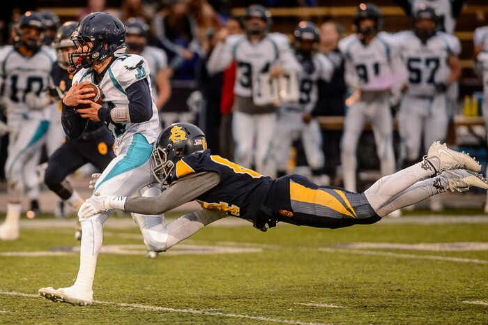 (Trent Nelson | The Salt Lake Tribune)  Summit Academy's Adri Jefferson dives at Juan Diego's Dallen Davis. Summit Academy faces Juan Diego High School in a class 3A state semifinal football game at Weber State University's Stewart Stadium, Saturday November 4, 2017.