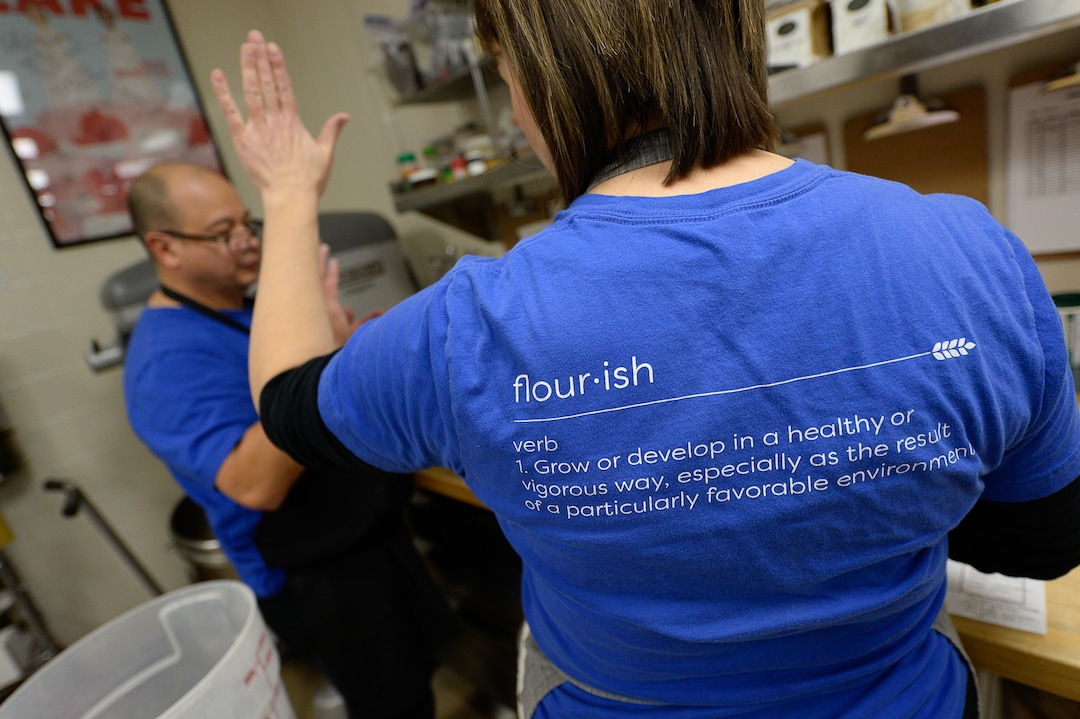 (Francisco Kjolseth  |  The Salt Lake Tribune)  Flourish Bakery needs to find a new home before Christmas. The non-profit bakery teaches those who have been incarcerated or recovering from substance abuse the art of baking as Aimee Altizer, Executive Director gives intern Dennis Sisneros a high five as they figure out a recipe. The bakery has been housed at SLCC's South City campus, but the college has said they can no longer use the space.