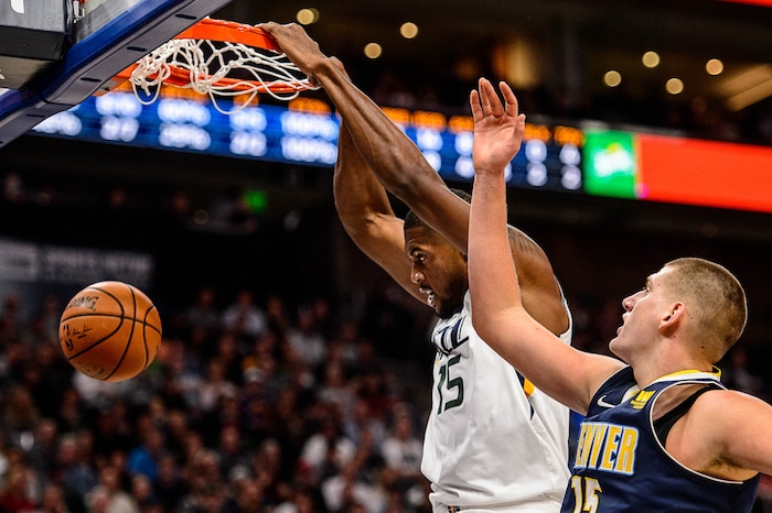 (Trent Nelson | The Salt Lake Tribune)  Utah Jazz forward Derrick Favors (15) dunks the ball, with Denver Nuggets center Nikola Jokic (15) defending, as the Utah Jazz host the Denver Nuggets, NBA basketball in Salt Lake City, Wednesday October 18, 2017.