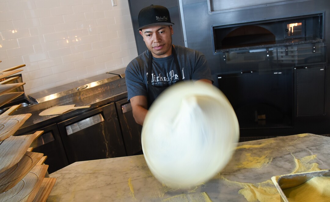(Francisco Kjolseth  |  The Salt Lake Tribune)  Alex Sanchez prepares a pizza at Wicked Peel Pizza Kitchen in Riverton.