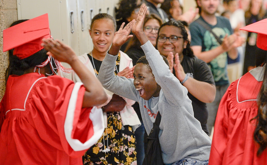 (Francisco Kjolseth  |  The Salt Lake Tribune)  Fehmy Suliman, a 7th grader at Glendale Middle School, celebrates East High graduating seniors as they parade through  the school on May 29 in hopes of inspiring younger students to work towards graduation.