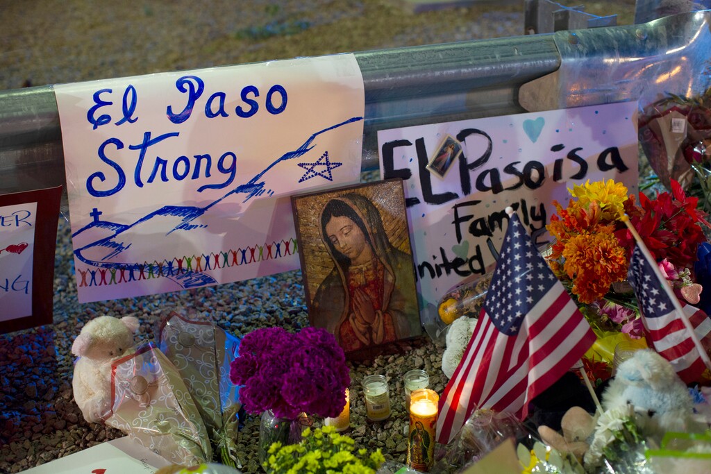 (Andres Leighton | AP file photo) A Virgin Mary painting, flags and flowers adorn a makeshift memorial for the victims of the mass shooting at a Walmart in El Paso, Texas, Aug. 4, 2019. The vast majority of mass shooters have acquired their firearms legally with nothing in their background that would have prohibited them from possessing a gun. But there have been examples of lapses in the background check system that allowed guns to end up in the wrong hands.