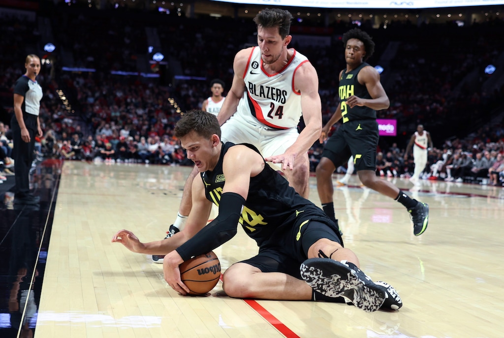 Utah Jazz center Walker Kessler dives for a loose ball in front of Portland Trail Blazers forward Drew Eubanks during the first half of an NBA preseason basketball game in Portland, Ore., Tuesday, Oct. 4, 2022. (AP Photo/Craig Mitchelldyer)
