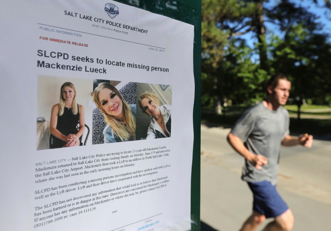 (Rick Bowmer  |  AP)   Joggers runs pass a poster of MacKenzie Lueck at Liberty Park Monday, June 24, 2019, in Salt Lake City.