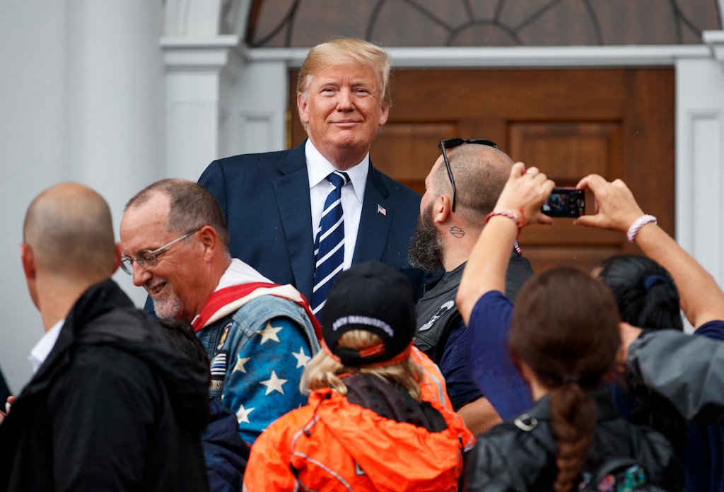 President Donald Trump visits with members of Bikers for Trump and supporters, Saturday, Aug. 11, 2018, outside the clubhouse of Trump National Golf Club in Bedminster, N.J. (AP Photo/Carolyn Kaster)