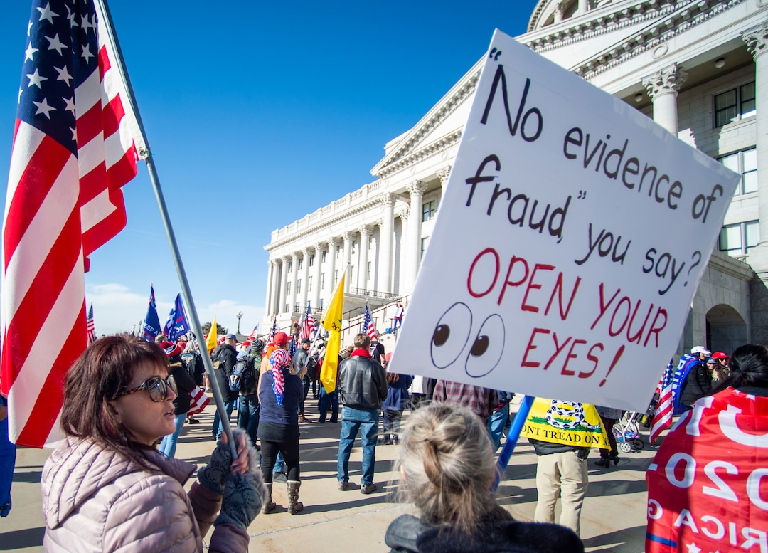 (Rick Egan | The Salt Lake Tribune). A small crowd of Trump protesters gather at the capitol with signs, flags and guns on Wednesday, Jan. 6, 2021.