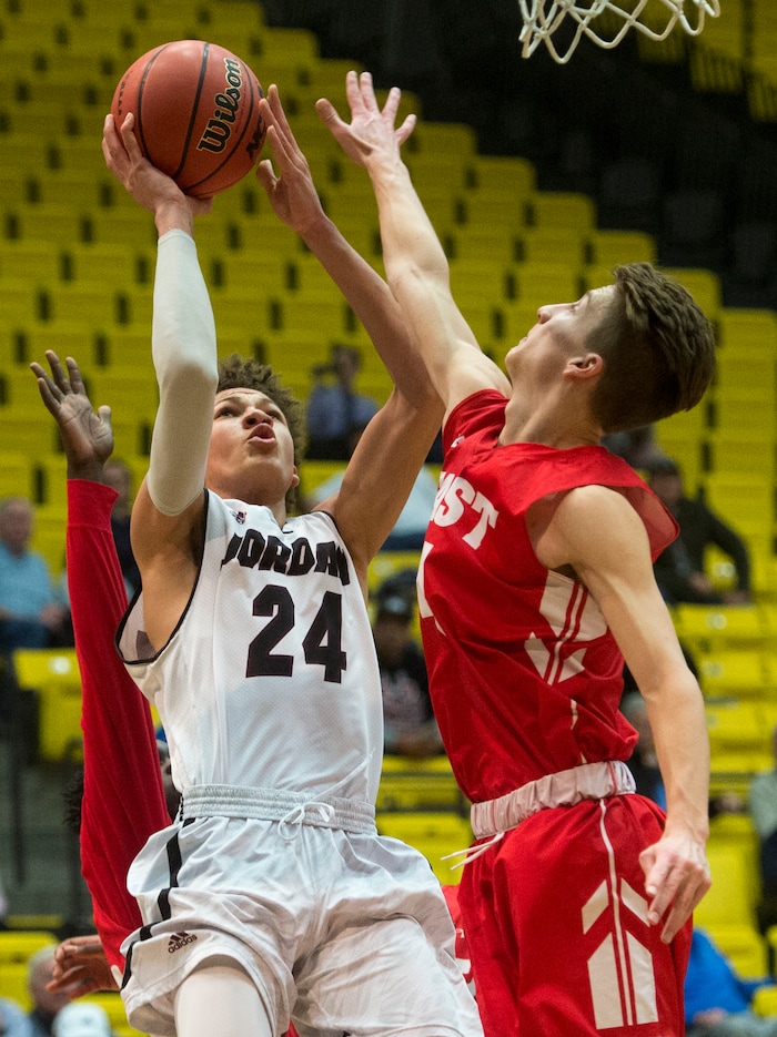 (Rick Egan  |  The Salt Lake Tribune)  Jordan Beatdiggers Terryn Mosley, takes a shot as East Leopards Taylor Zwick (4) defends, in 5A basketball playoff action between the East Leopards and the Jordan Beatdiggers at the UCCU Center in Orem, Monday, Feb. 26, 2018.
