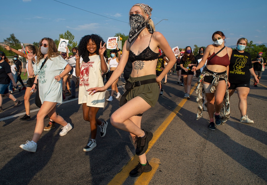 (Rick Egan  |  The Salt Lake Tribune)     Protesters dance through the neighborhood in Rose Park, during the Dance Dance for Revolution protest for racial equality, on Sunday, Aug. 23, 2020. The protest was in memory of Jovany Mercardo who was shot last August by Ogden police by four officers, hitting his body sixteen times.