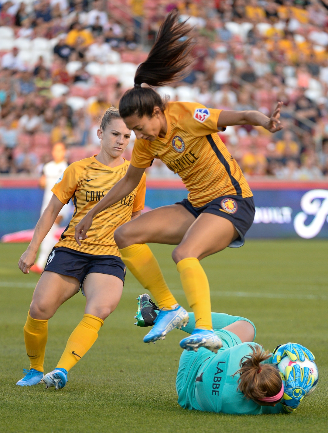 (Francisco Kjolseth  |  The Salt Lake Tribune)  Utah Royals FC forward Christen Press (23) leaps over North Carolina Courage goalkeeper Stephanie Labb (1) as Utah Royals FC hosts the North Carolina Courage at Rio Tinto Stadium in Sandy, Utah on Saturday, July 27, 2019.