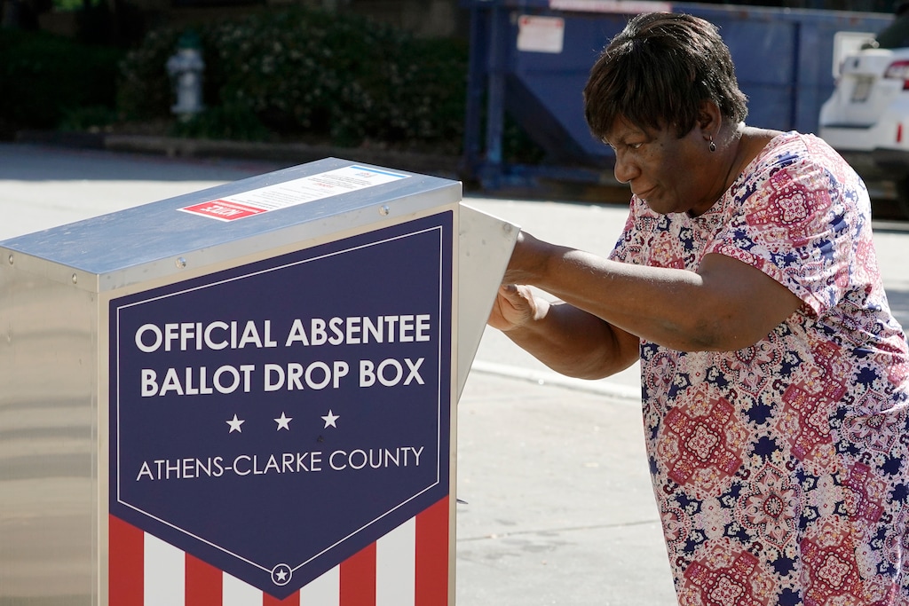 (John Bazemore | AP photo)
In this Oct. 19, 2020, photo, a voter drops their ballot off during early voting in Athens, Ga. After record turnout led to stunning GOP losses in the once reliably red state, Republican lawmakers are forging ahead with an aggressive slate of voting legislation that critics argue is tailored toward curtailing the power of Black voters.