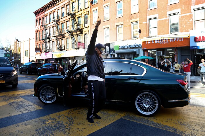 A man stands outside of his car blocking Fulton Street with his fist to the sky celebrating the victory of Joe Biden over President Donald Trump on Saturday, Nov. 7, 2020. (AP Photo/Jessie Wardarski)