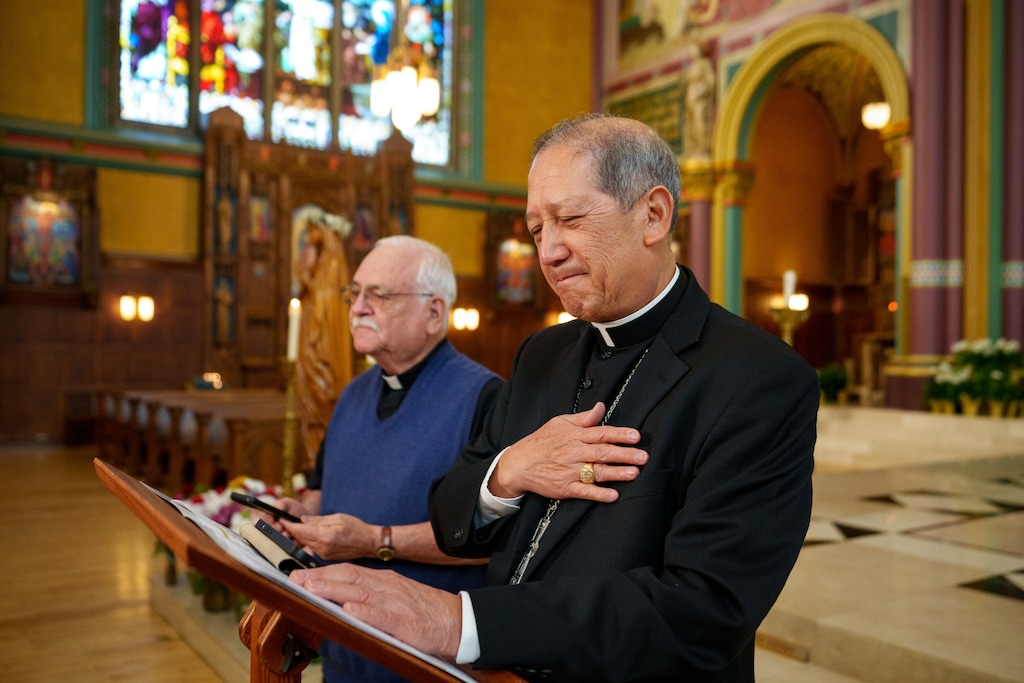 (Trent Nelson | The Salt Lake Tribune) Bishop Oscar Solis listens to the blessing of Pope Leo XIV, streamed from his phone, at the Cathedral of the Madeleine in Salt Lake City on Thursday, May 8, 2025. At left is Father Martin Diaz, rector of the Cathedral of the Madeleine.
