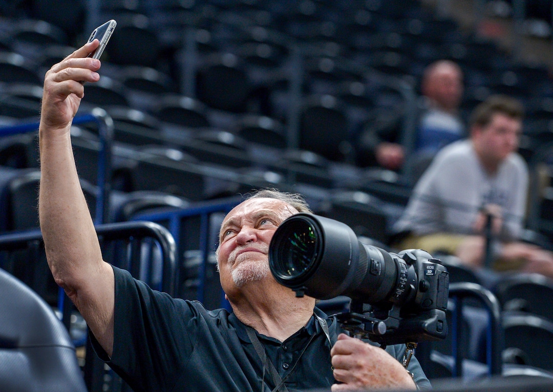 Leah Hogsten  |  The Salt Lake Tribune  Independent sports photographer Barry Judd of Salt Lake City snaps a selfie while shooting Auburn's practice prior to Thursday's  2019 NCAA Division I Men's Basketball Championship's first round games. 