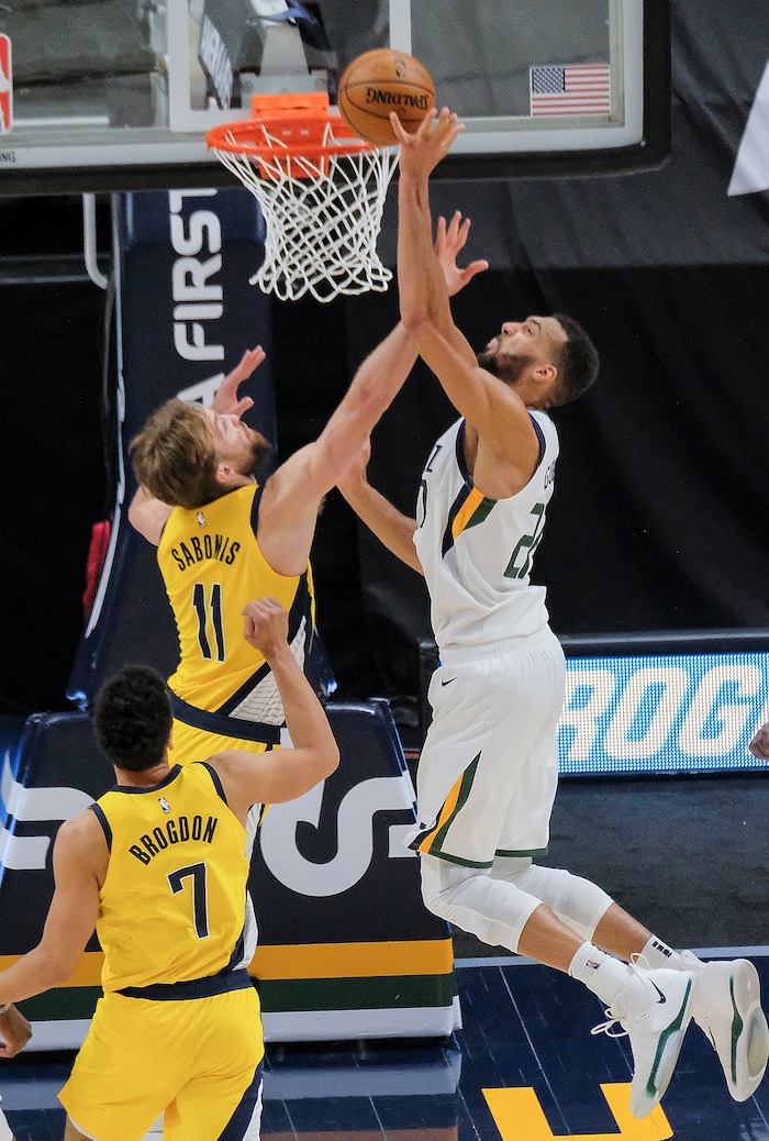 Leah Hogsten | The Salt Lake Tribune Utah Jazz center Rudy Gobert (27) and Indiana Pacers forward Domantas Sabonis (11) at the net as the Utah Jazz host the Indiana Pacers, April 16, 2021 at the Vivint Arena.
