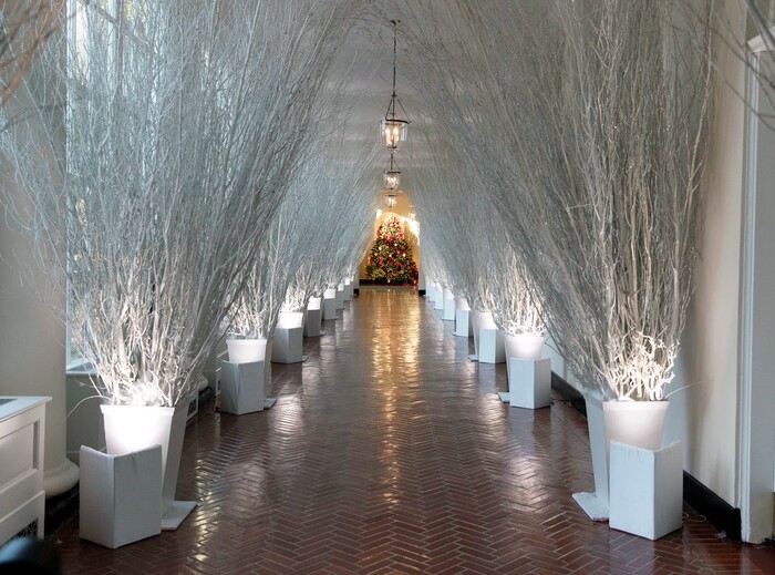 The East Colonnade is decorated with white branches that lead to a Christmas tree in the the East Garden Room during a media preview of the 2017 holiday decorations at the White House in Washington, Monday, Nov. 27, 2017. (AP Photo/Carolyn Kaster)