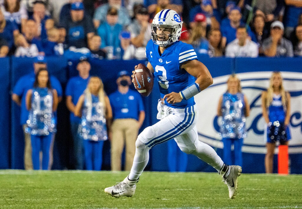 (Rick Egan | The Salt Lake Tribune) Brigham Young Cougars quarterback Jaren Hall (3) rolls out of the pocket before completing a pass for a first down, in football action between the Utah Utes and the Brigham Young Cougars at Lavell Edwards Stadium in Provo, on Saturday, Sept. 11, 2021.