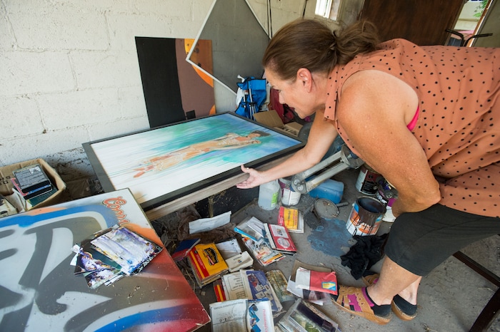 (Rick Egan  |  The Salt Lake Tribune)  Emmy Thomson sorts through photos and memorabilia that was destroyed when water flooded her garage, at her home on Lincoln Street. Tuesday, August 1, 2017.