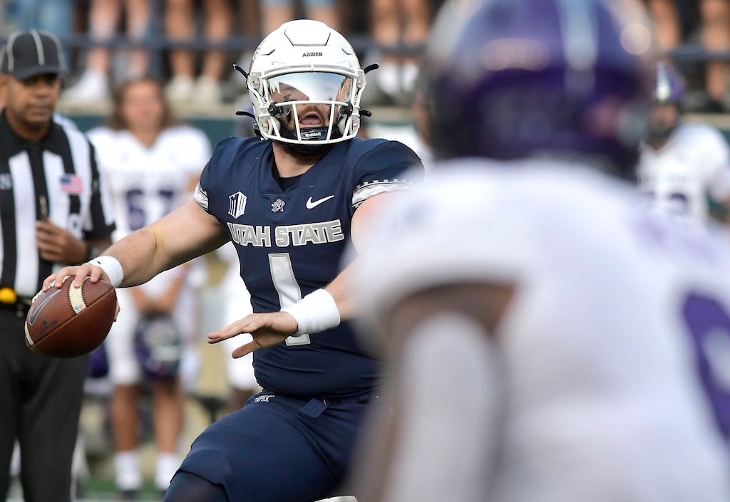 (Eli Lucero | The Herald Journal via AP) Utah State quarterback Logan Bonner (1) looks to throw the ball against Weber State in the first half of an NCAA college football game Saturday, Sept. 10, 2022, in Logan, Utah.