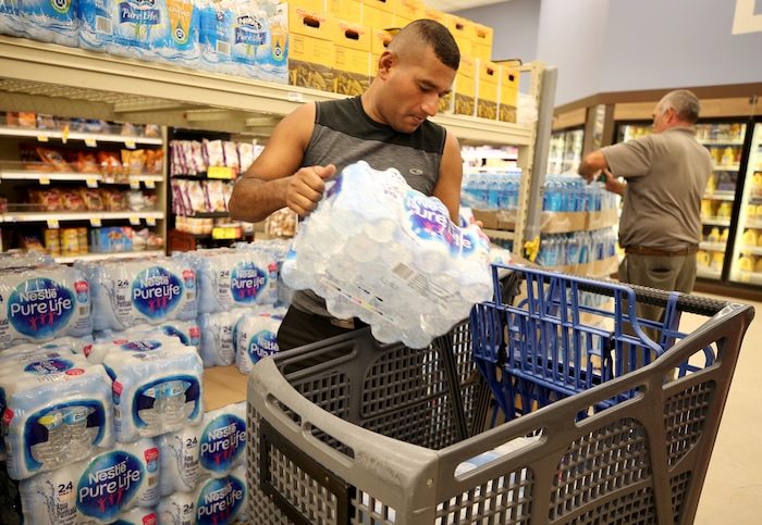 (Jennifer Reynolds | The Galveston County Daily News) Jose Contreras stocks up on bottled water in preparation of Hurricane Harvey on Thursday, Aug. 24, 2017, at the Kroger in Galveston, Texas.  The National Hurricane Center is forecasting Harvey will become a major hurricane to hit the middle Texas coastline.