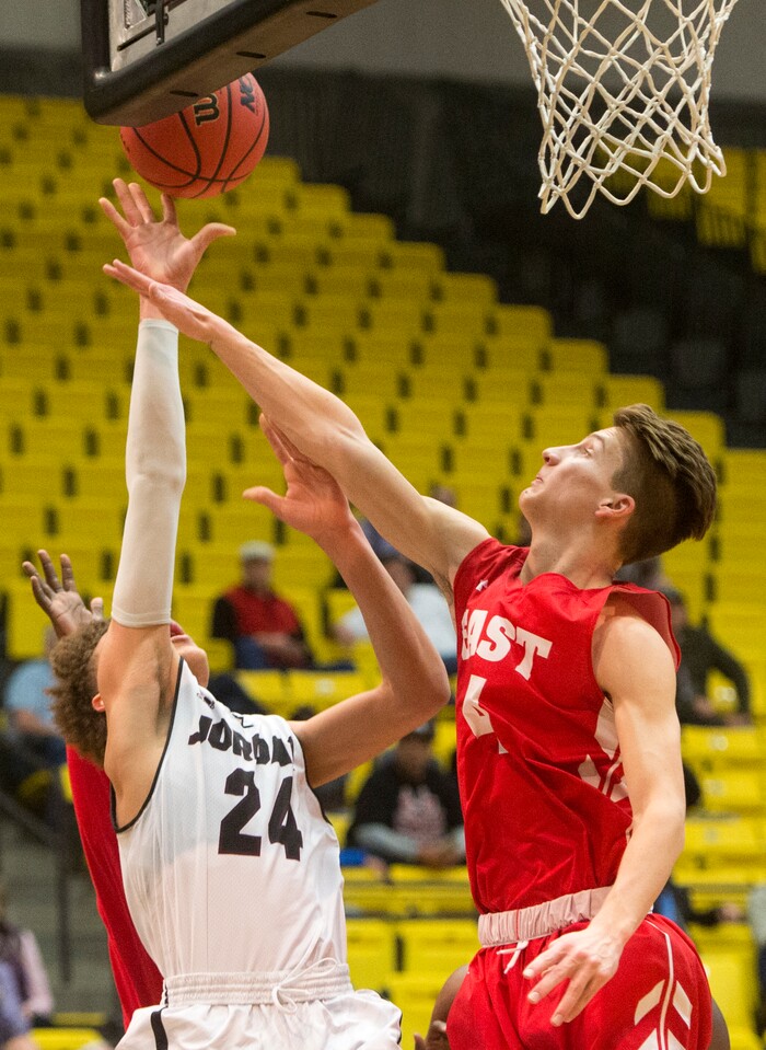 (Rick Egan  |  The Salt Lake Tribune)  Jordan Beatdiggers Terryn Mosley, takes a shot as East Leopards Taylor Zwick (4) defends, in 5A basketball playoff action between the East Leopards and the Jordan Beatdiggers at the UCCU Center in Orem, Monday, Feb. 26, 2018.